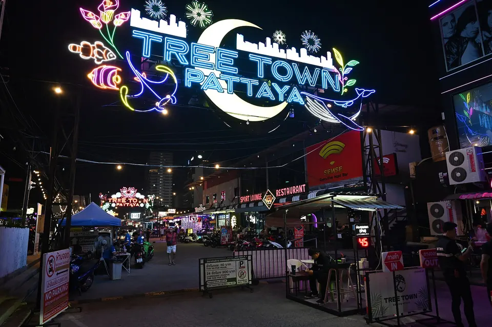 Photo: the neon arch reading Tree Town Pattaya over the lane into the night market, food stalls and bars on both sides